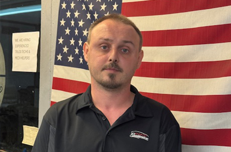 Man standing near American flag