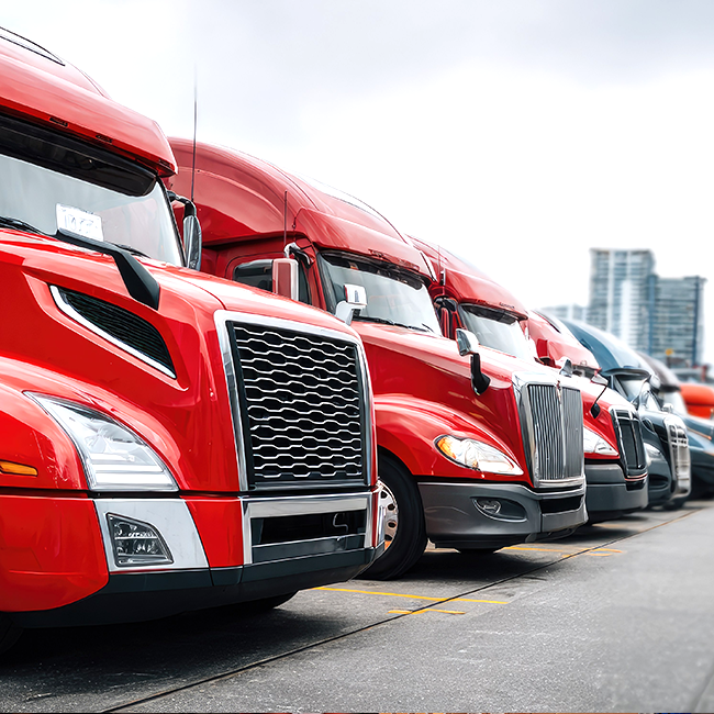 Red semi trucks parked outside